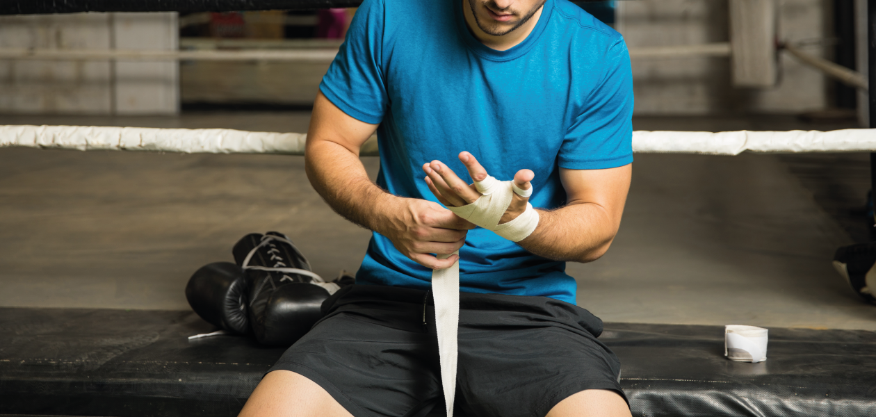 Man putting on Hand Wraps before Boxing